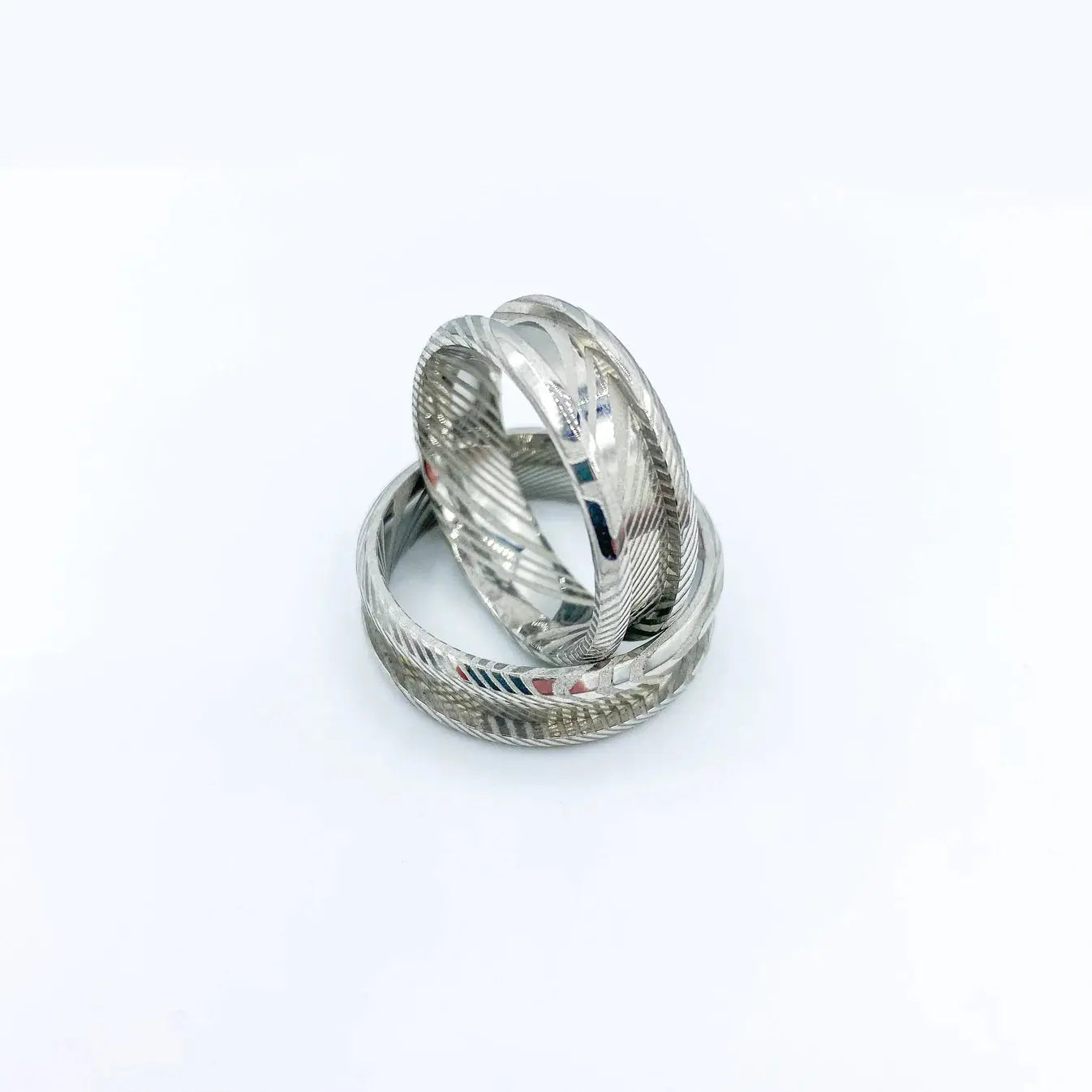 Damascus single channel ring for custom rings on a white background