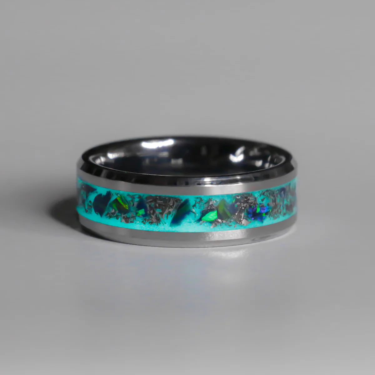 Ring with turquoise inlay and metallic band on gray background