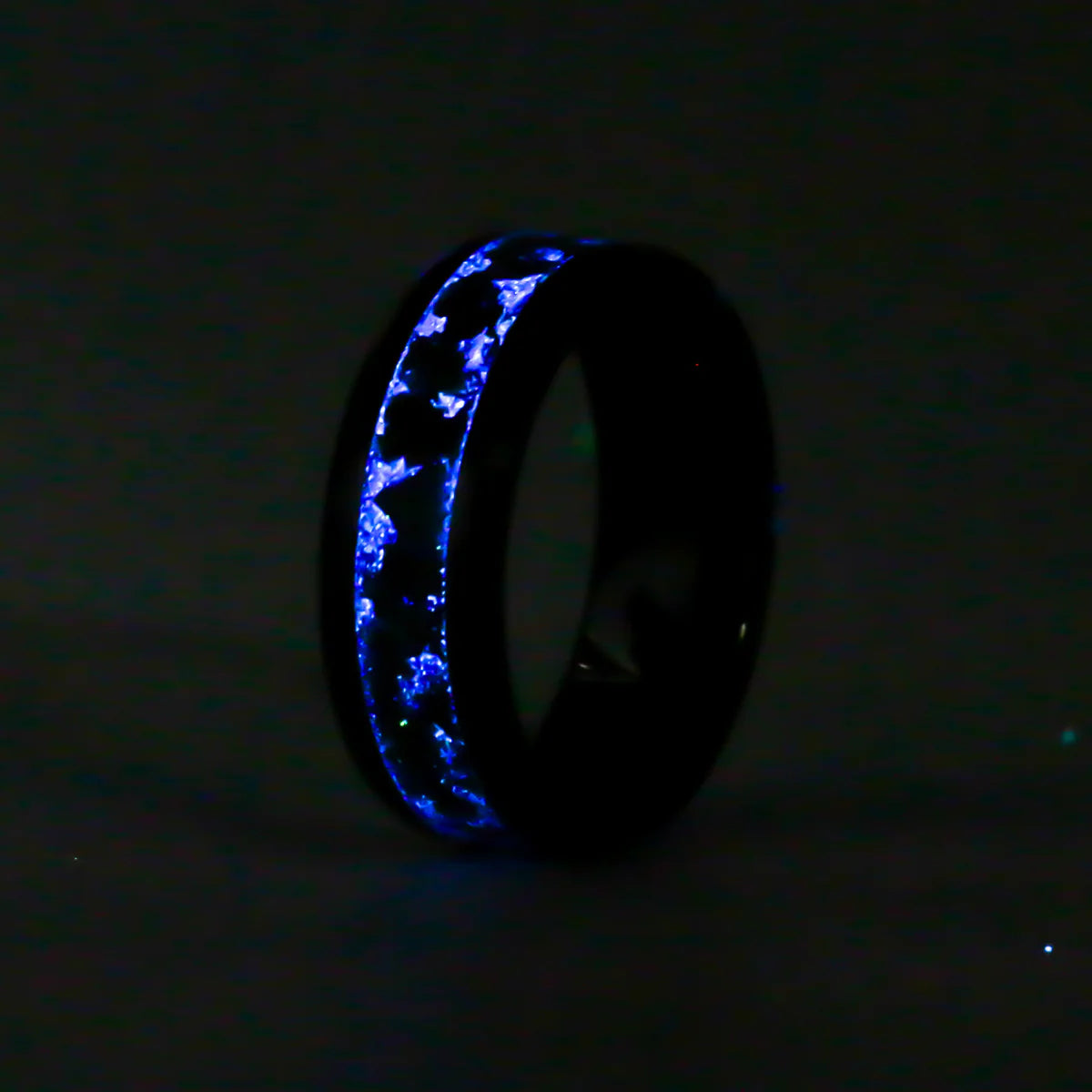 Black ceramic ring with Glowing blue ring on a black background